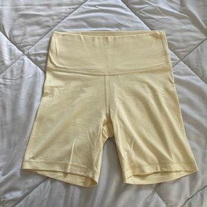 Aritzia Tna TNABUTTER Atmosphere Hi-Rise 7” Biker Short in color Butter Yellow
